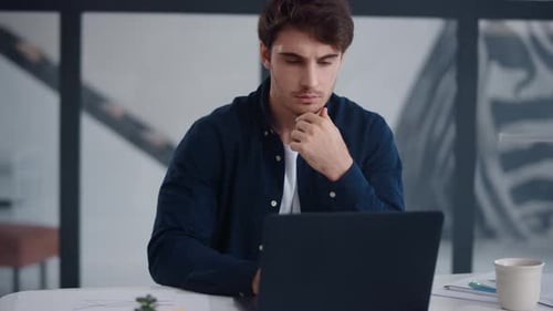Focused Business Man Working Laptop in Office. Guy Reading Text on Notebook