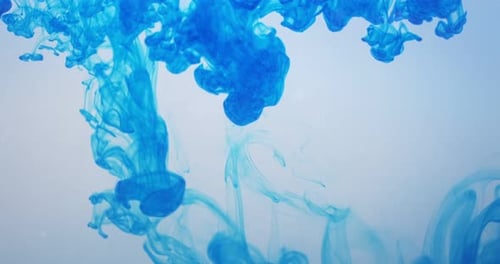 Abstract Footage of Blue Dye Pouring Into Water