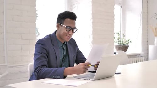 Happy Businessman Reading Documents in Office Successful Project