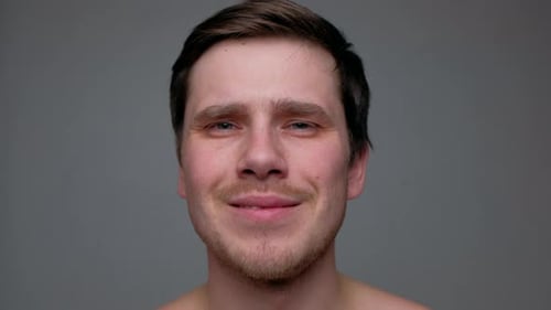 Young Adult Man Smiling in a Studio Close Up