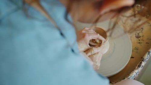 Close-up of Female Potter Molding Clay Into Beautiful Handmade Pot on Throwing Wheel