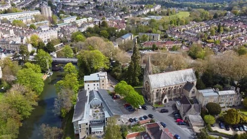 Quaint southern UK suburban setting, church, bridge, residential areas amongst vast green areas.