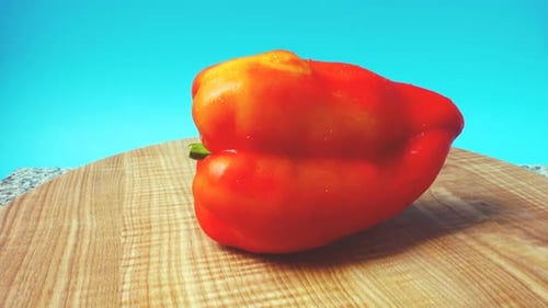 Red Bell Pepper Rotating on Cutting Board