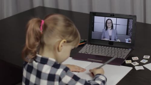 Child Learning Online with Teacher on Laptop