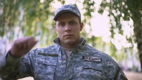 Soldier Saluting in Camouflage Military Uniform and Cap