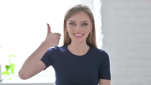 Smiling Woman Giving Thumbs Up of Approval
