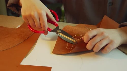 An Experienced Tanner in the Process of Creating a Women's Handbag. Cuts Off the Excess Sartorial