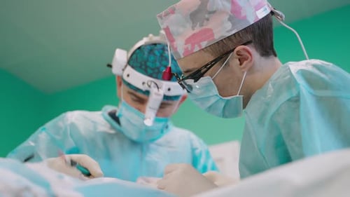 Surgeons Performing Operation in a Hospital Setting