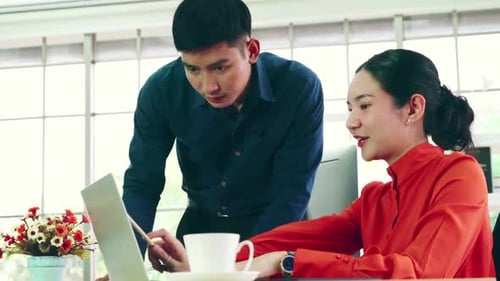 Two Business People Talk Project Strategy at Office