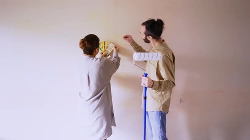 Couple Selecting Paint Color for Home Wall