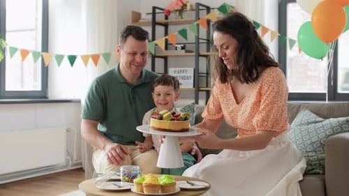 Family Celebrates Birthday with Cake and Cupcakes