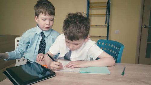 Boys Study Together with Tablet and Notebook