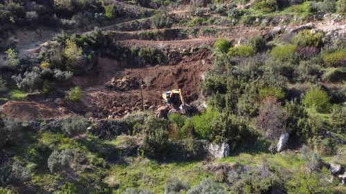 Excavator Digging into Hillside in Rural Setting