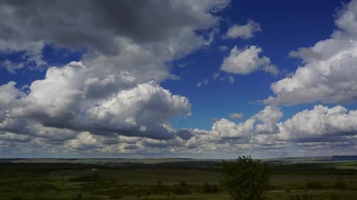 Rolling Clouds over a Rural Landscape on Sunny Day