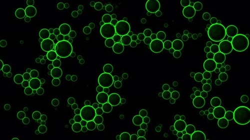 Oil green drops moving in water. Abstract background