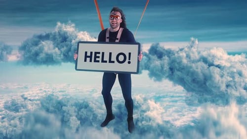 Man with Hello Sign Suspended in Dreamy Blue Sky