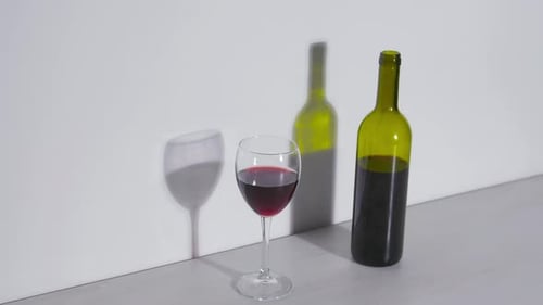 Still Shot of Red Wine Bottle and Glass