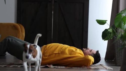 Man Does Sit Ups with Dog Watching