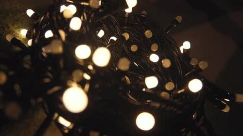 Closeup Shot Hank of Christmas Garland with Golden Lights on a Playd