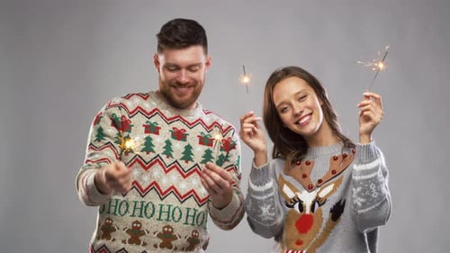 Smiling Couple Celebrating with Sparklers in Studio