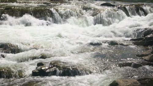 Waterfall Flow Over Rocks in the River
