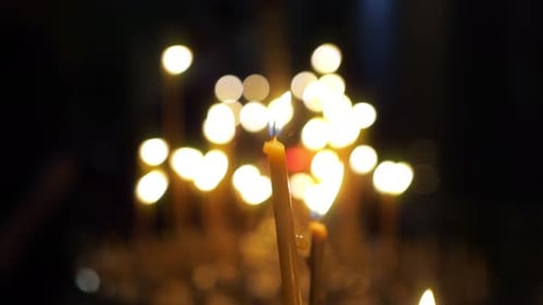 Burning Candles Illuminate the Dark Interior