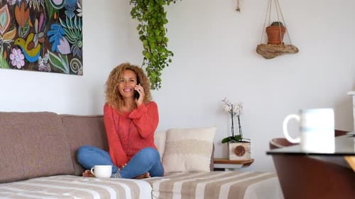 Woman Chatting on Phone While Relaxing at Home