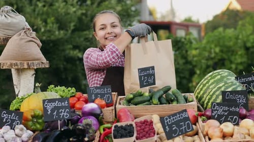 Smiling Woman at Rural Fresh Produce Stand