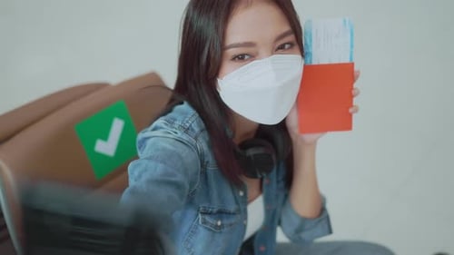 Young Woman Filming Herself at Airport with Passport