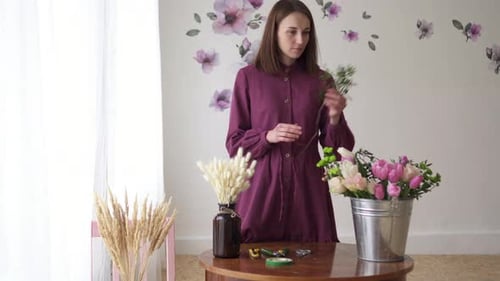 Woman Florist Makes Bouquet of Flowers in Workshop
