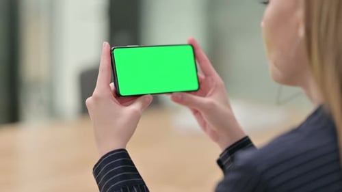Rear View of Businesswoman Watching Smartphone with Chroma Screen