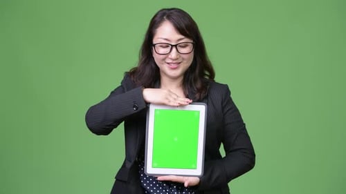 Woman Holding Tablet Device with Green Screen