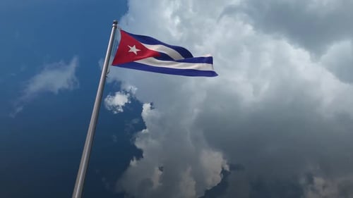 Cuba Flag Waving on Flagpole Against Cloudy Sky