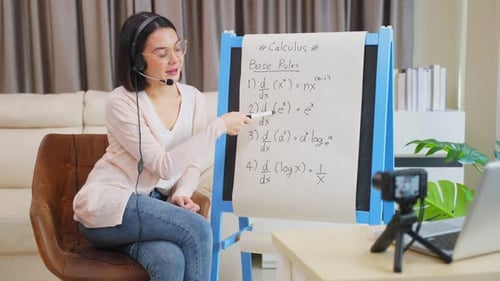 Asian school young woman teacher working from home teach online math subject to student in house.