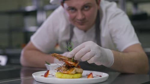 Chef Plating Gourmet Shrimp and Pineapple Dish