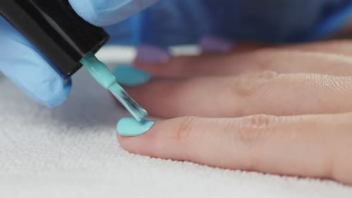 Young Woman Paints Her Nails with Natural Gel Base. Nails Manicure.