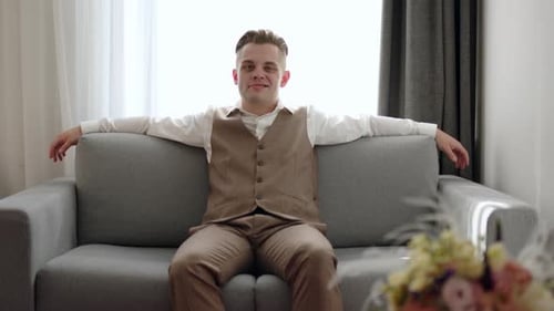 Young Adult Man Talking Indoors Before a Wedding