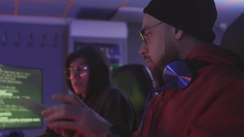 Two Male Programmers Working Together at Night