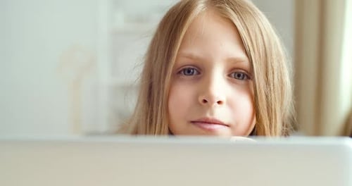 Girl Using a Computer at Home, Close Up