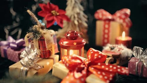 The Hand Is Put a Christmas Gift Box, Christmas Ball on Glow Bokeh Lights Background