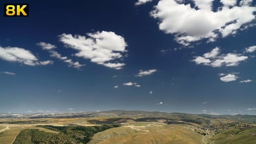 Cloud Movements at Clean Sunny Sky in Mixed Terrain