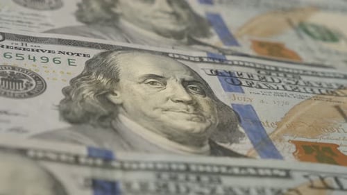 Slow tilt on USA dollar banknotes close-up 4K 2160p 30fps UltraHD footage - Panning over rows of US