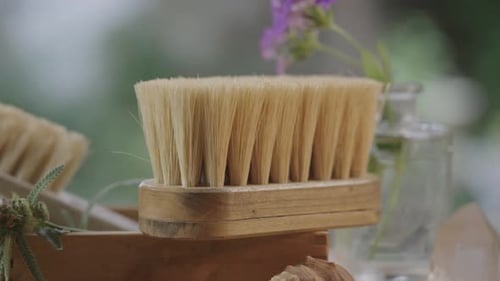 Natural Bath Products with Wooden Brush and Flowers