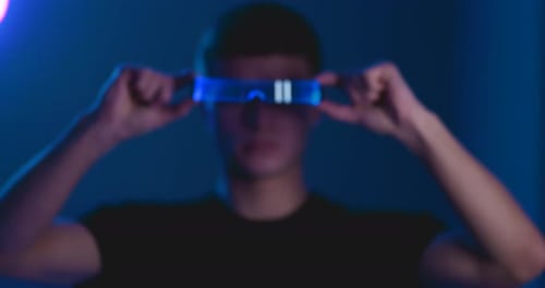 Young Adult Wearing Futuristic Glowing Glasses
