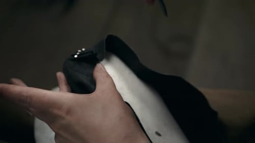 Hands Attaching Fasteners to Material with Tools