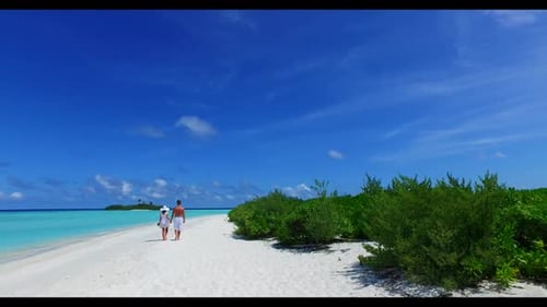 Family of two in love on exotic tourist beach time by blue ocean with white sandy background of the