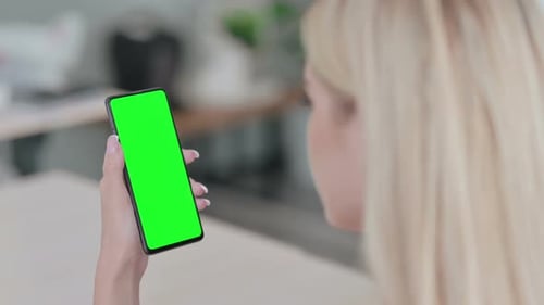 Woman Holds Phone with Green Screen Display