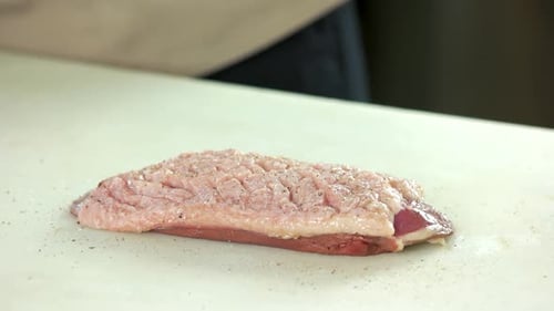 Chef Seasoning and Preparing Raw Meat Close Up