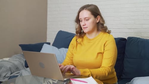 Woman Working on Laptop at Home