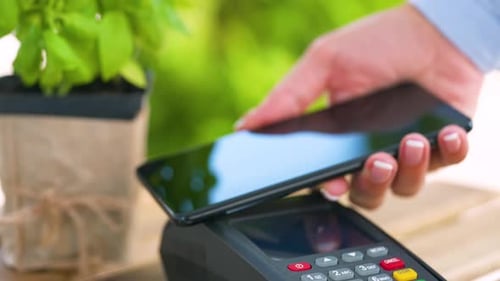 Hand Making Payment with Smartphone and Card Reader